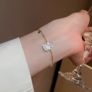Detail of 18k gold plated gourd bracelet with white zircon inlay worn by a model