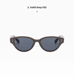 Detail of grey cat-eye sunglasses featuring metal rivets and UV-protective lenses