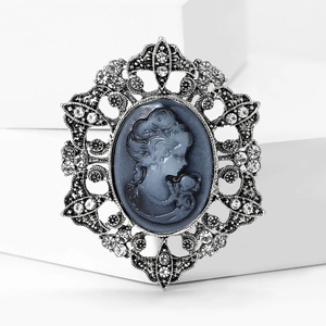 Vintage silver-plated brooch featuring grey portrait cameo and sparkling rhinestones