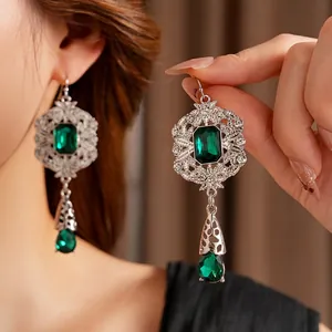 Vintage silver-plated emerald green drop earrings with intricate hollow-out geometry