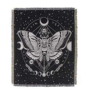 Bohemian black and white moth blanket with moon phases and fringe accents for camping