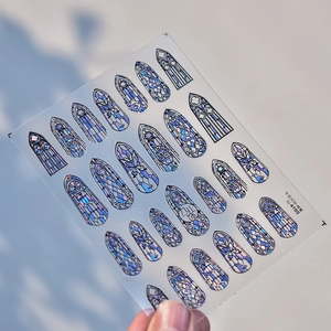 Macro detail of laser iridescent Gothic window nail art stickers with metallic finish