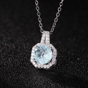 Macro view of light blue square zircon pendant with shimmering diamond-like setting