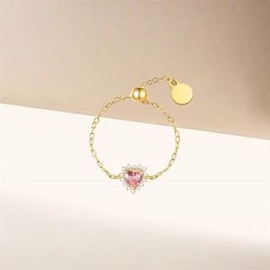 Detailed macro view of the pink heart gemstone with adjustable gold chain link design
