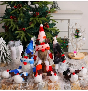 Three plush Christmas gnomes with antlers and long legs set on a festive indoor wooden floor