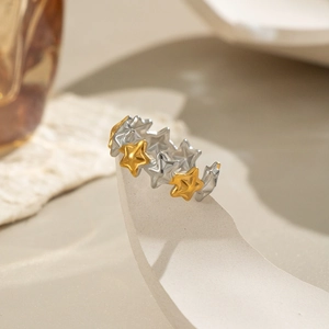Macro detail of polished two-tone interlocking stars ring in gold and silver finish