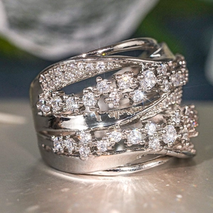 Close-up of elegant silver multi-layer crisscross ring with pavé-set white zircon stones