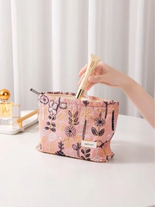 Pink floral embroidered makeup bag with zipper closure and spacious square base design