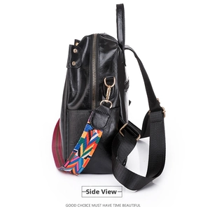 Side view of black patent leather backpack with colorful geometric woven wide shoulder strap