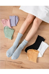 Detailed close-up of ribbed cotton socks with ruffled edges in various pastel colors