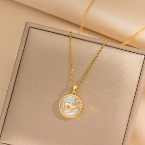 Luxurious gold necklace with mother-of-pearl shell pendant and diamond whale motif