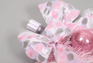 Detail of pink bow with silver snowflake print and glitter ball for Christmas hanging decor
