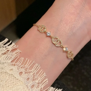 Close-up of 18k gold plated CD link bracelet with sparkling circular zircon stones