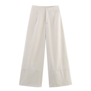 Detailed close-up of high-waisted linen-style wide-leg pants with raw hem design