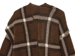 Detailed close-up of brown plaid knitted cardigan featuring classic fuzzy texture and pattern