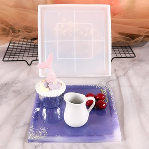 Detailed view of a square silicone mold with a finished purple resin tray and silver foil flakes