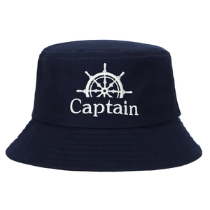 Close-up of white Captain embroidery and helm wheel on navy blue cotton bucket hat