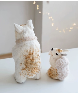Detail of white and gold festive squirrel figurine with sparkling glitter for Christmas decor