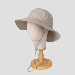 Close-up of lightweight khaki outdoor sun hat with wide brim and adjustable chin strap