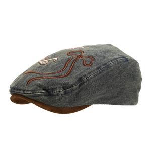 Vintage denim beret with brown brim and embroidery from a professional side profile view
