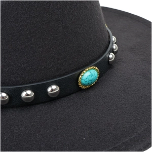 Detail of grey wool felt hat with leather band, silver studs and green gemstone
