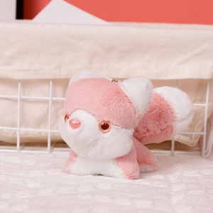 Close-up of a mini pink husky plush pendant with soft texture and metal keychain attachment