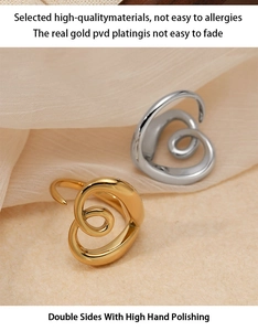 Macro detail of polished stainless steel heart ring with high-quality PVD gold plating