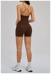 Detail of cross-back yoga top and high-waisted shorts in dark brown matte fabric