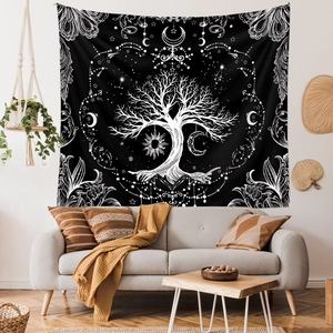 Detail of life tree tapestry with celestial moon and sun patterns for wall decor