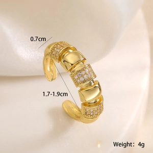 Macro view of 18K gold plated ring featuring triple rows of zircons on silk fabric