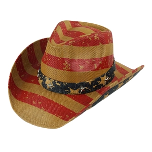 Detail of western cowboy straw hat featuring red stripes and star buckle band