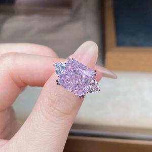Macro shot of a radiant cut pink sapphire ring with triangular side diamonds in silver