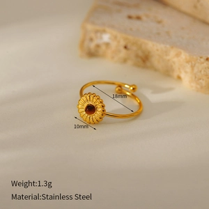 Macro shot of gold sunflower ring with brown stone inlay and stainless steel details