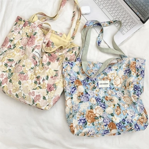 Flat lay of floral canvas tote bags with LOVE SOZAKKA label and casual accessories
