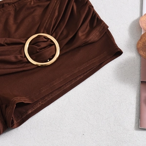 Detail of dark brown ruched fabric with premium golden metal ring hardware decoration