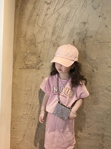 Detail of silver sequin crossbody bag styled with pink girls summer T-shirt and shorts