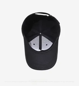 Detail of black baseball cap interior with white lining and adjustable strap