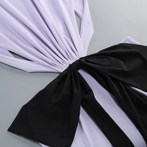 Detail of lavender and black color-block dress with a large decorative front knot design