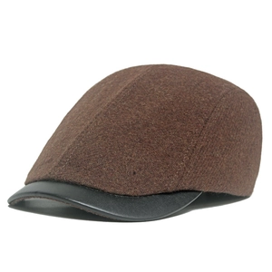 Vintage brown wool newsboy cap for women with a premium black leather brim and retro texture