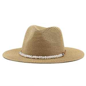 Classic straw sun hat with wide brim and decorative stone beads for summer travel