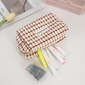Detailed close-up of a bubble texture pencil case holding highlighters and stationery