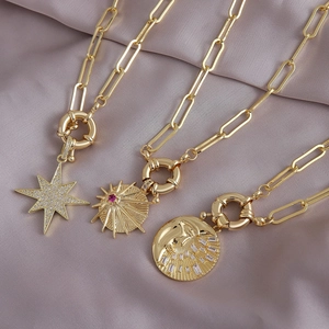 18K gold plated paperclip chain necklace with celestial sun, moon, and star pendants