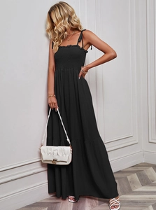 Detail of black strapless maxi dress with textured fabric and thin spaghetti straps