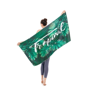 Microfiber beach towel with green tropical leaf print and Tropical Dream text