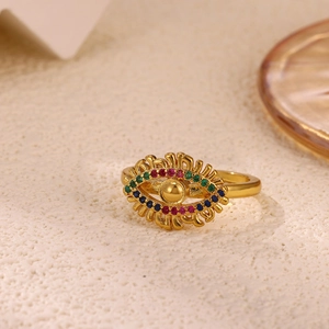 Detail of gold evil eye ring featuring colored zircons and metal eyelashes decoration