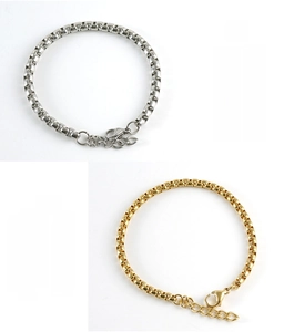 Detailed close-up of stainless steel box chain bracelets in silver and gold with lobster clasp