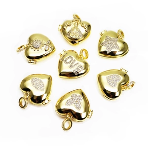 Detail view of seven gold-plated heart lockets with LOVE engraving and zircon stones
