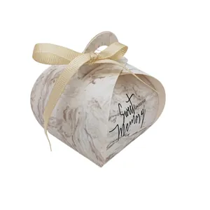 Detail of marble pattern wedding favor box with gold ribbon and Sweet Memory text