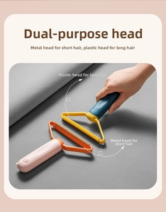 Close-up of dual-head lint remover with pink handle cleaning gray fabric surface