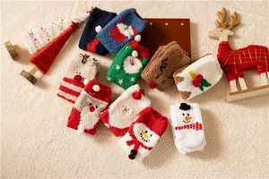 Close-up of cozy coral fleece Christmas socks with festive patterns on a plush rug